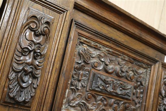 An early 20th century carved oak fire surround, W.188cm H.182cm